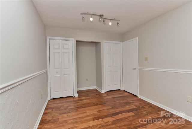 2706 Bremer Ct, Charlotte, NC 28210 - unfurnished bedroom with wood finished floors and two closets
