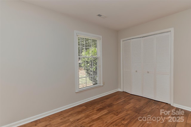 2706 Bremer Ct, Charlotte, NC 28210 - unfurnished bedroom with dark wood-type flooring and a closet