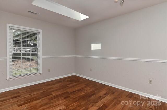 2706 Bremer Ct, Charlotte, NC 28210 - unfurnished room featuring a skylight, plenty of natural light, and wood finished floors