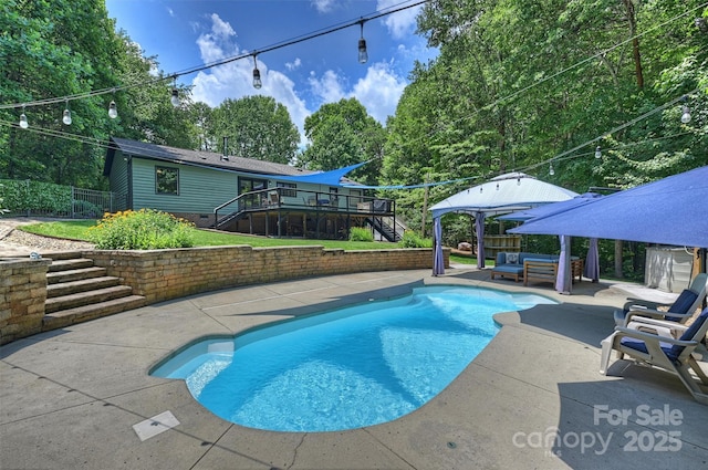6411 Glenn Teague Rd, Charlotte, NC 28216 - view of pool featuring stairs, a wooden deck, a patio, a fenced backyard, and an outdoor living space