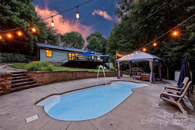 6411 Glenn Teague Rd, Charlotte, NC 28216 - pool at dusk featuring a gazebo, stairway, a deck, and a patio