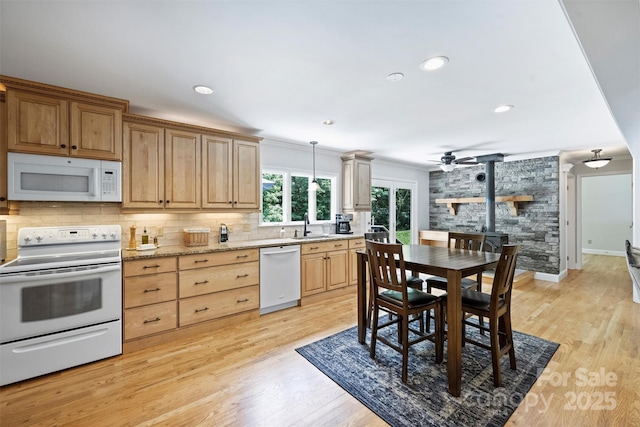 6411 Glenn Teague Rd, Charlotte, NC 28216 - kitchen with white appliances, tasteful backsplash, a ceiling fan, light brown cabinets, and light wood finished floors