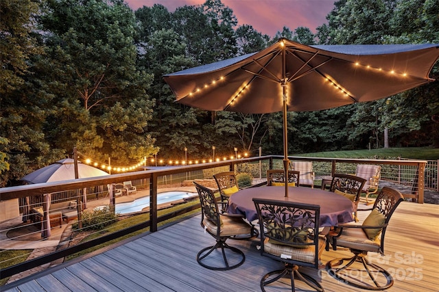 6411 Glenn Teague Rd, Charlotte, NC 28216 - deck at dusk with outdoor dining area and view of scattered trees
