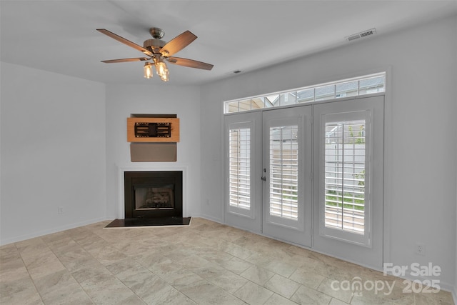 222 Ross Moore Ave, Charlotte, NC 28205 - unfurnished living room with a fireplace, a ceiling fan, and french doors