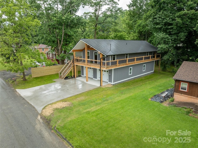 2513 Rolfe St, Hendersonville, NC 28791 - view of front facade with a front lawn, driveway, stairs, an attached garage, and a metal roof