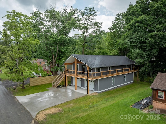 2513 Rolfe St, Hendersonville, NC 28791 - back of house with a yard, stairs, driveway, a metal roof, and a deck