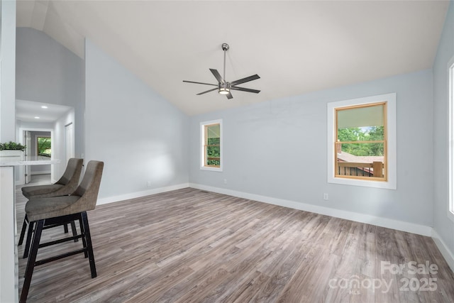 2513 Rolfe St, Hendersonville, NC 28791 - unfurnished living room with wood finished floors, ceiling fan, plenty of natural light, and high vaulted ceiling