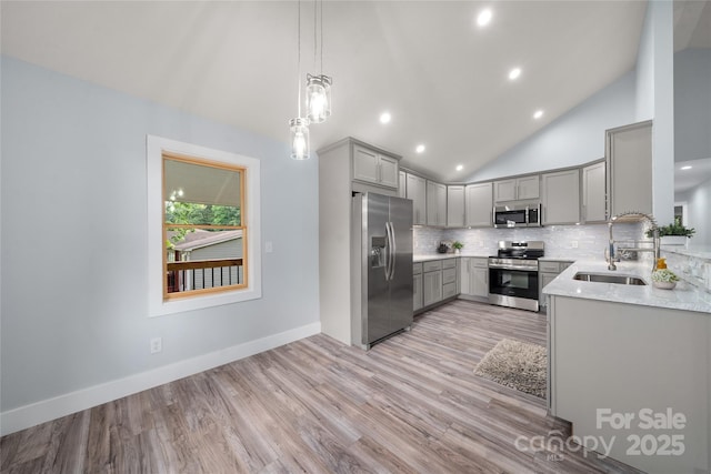 2513 Rolfe St, Hendersonville, NC 28791 - kitchen with stainless steel appliances, gray cabinetry, backsplash, vaulted ceiling, and recessed lighting