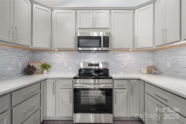 2513 Rolfe St, Hendersonville, NC 28791 - kitchen with appliances with stainless steel finishes, gray cabinets, decorative backsplash, and light stone counters