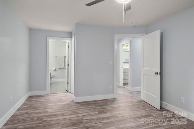 2513 Rolfe St, Hendersonville, NC 28791 - unfurnished bedroom featuring wood finished floors, ensuite bath, and a ceiling fan