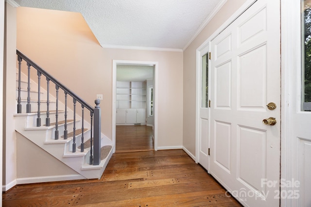204 S Deerfield Cir, Salisbury, NC 28147 - entryway featuring crown molding, wood-type flooring, a textured ceiling, and stairway
