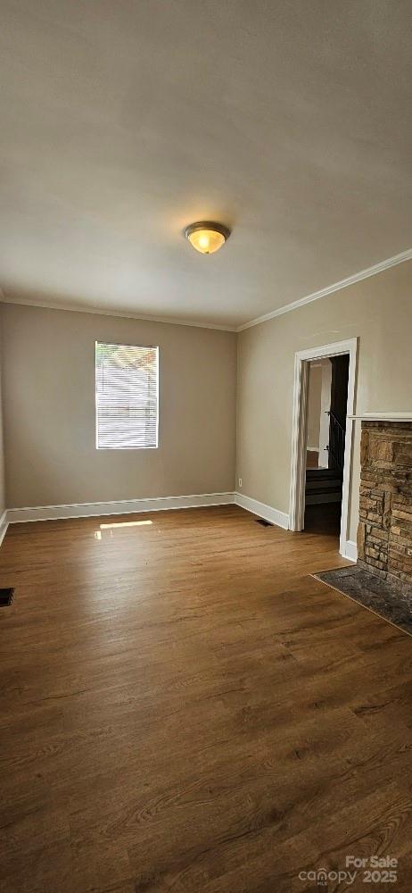 2828 Bellhaven Cir, Charlotte, NC 28214 - empty room featuring crown molding and dark wood finished floors