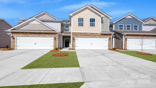 122 Sugg Trl, Weaverville, NC 28787 - view of front of home featuring stone siding, driveway, board and batten siding, and a front lawn