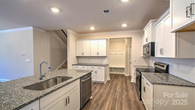 122 Sugg Trl, Weaverville, NC 28787 - kitchen with appliances with stainless steel finishes, white cabinets, tasteful backsplash, ornamental molding, and dark stone counters