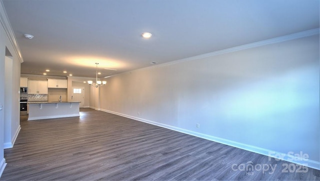 122 Sugg Trl, Weaverville, NC 28787 - unfurnished living room featuring crown molding, a chandelier, recessed lighting, and dark wood finished floors