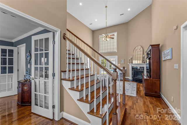 1236 James Farm Rd, Hickory, NC 28602 - stairs with a fireplace, wood finished floors, ceiling fan, ornamental molding, and recessed lighting