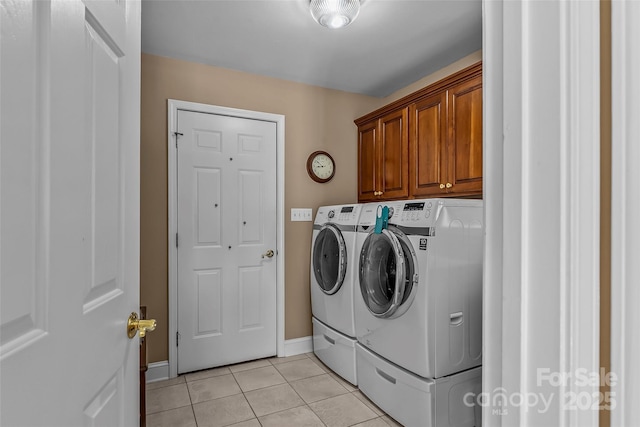 1236 James Farm Rd, Hickory, NC 28602 - laundry area featuring washing machine and dryer, light tile patterned flooring, and cabinet space