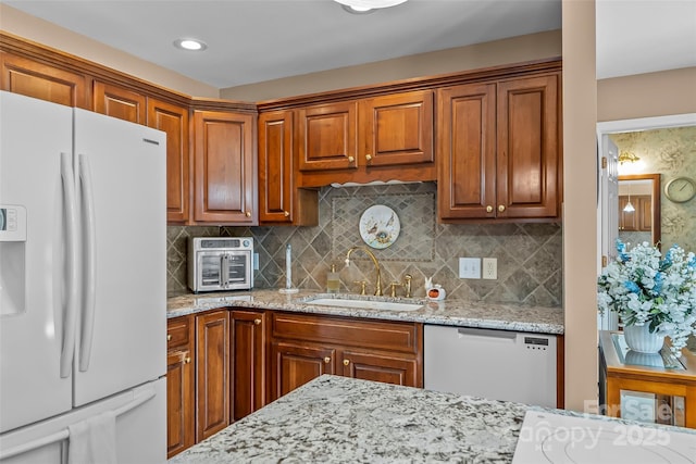 1236 James Farm Rd, Hickory, NC 28602 - kitchen with white appliances, light stone counters, backsplash, brown cabinetry, and recessed lighting