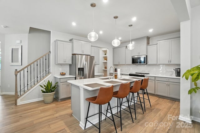 11246 Bartrams Way, Charlotte, NC 28278 - kitchen with appliances with stainless steel finishes, gray cabinets, backsplash, light wood-style flooring, and recessed lighting