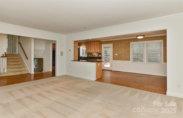 6117 Yellowood Rd, Charlotte, NC 28210 - unfurnished living room with stairway, carpet floors, ornamental molding, and wood finished floors