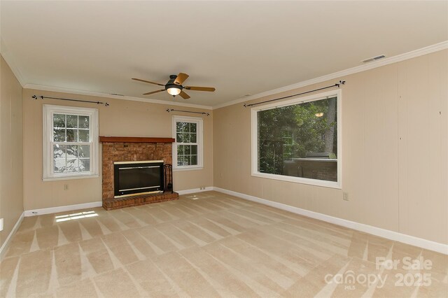 6117 Yellowood Rd, Charlotte, NC 28210 - unfurnished living room featuring a ceiling fan, ornamental molding, healthy amount of natural light, carpet floors, and a brick fireplace