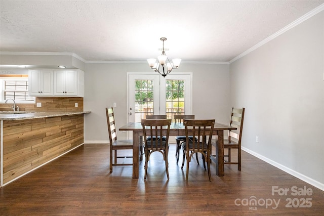 6811 Kluttz Rd, Concord, NC 28025 - dining space featuring dark wood-style flooring, a chandelier, and ornamental molding