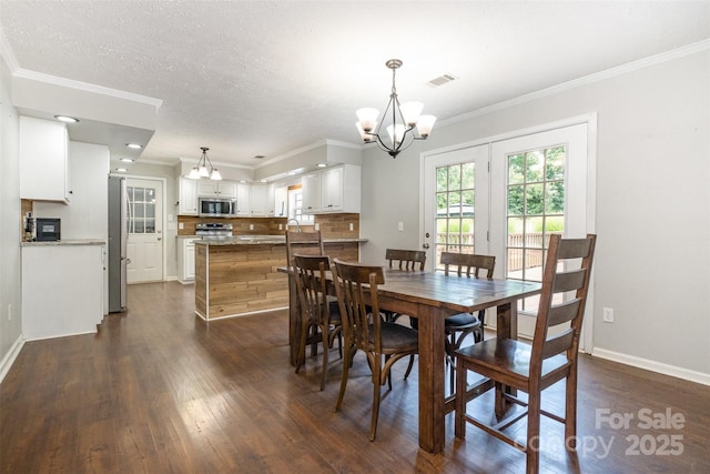 6811 Kluttz Rd, Concord, NC 28025 - dining room with dark wood-style floors, a chandelier, and crown molding