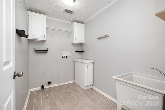 6811 Kluttz Rd, Concord, NC 28025 - washroom featuring washer hookup, cabinet space, a textured ceiling, wood tiled floors, and crown molding