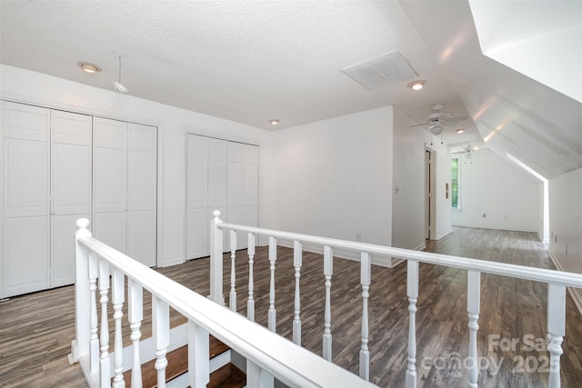 6811 Kluttz Rd, Concord, NC 28025 - corridor with wood finished floors, a textured ceiling, vaulted ceiling, and an upstairs landing