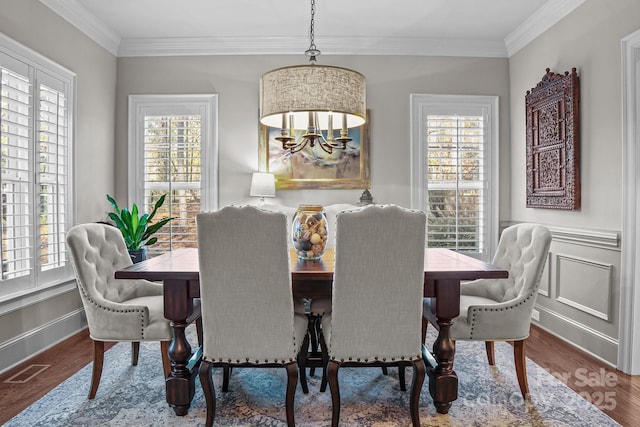 109 Trent Pines Dr, Mooresville, NC 28117 - dining space featuring ornamental molding, wood finished floors, a chandelier, and a wainscoted wall