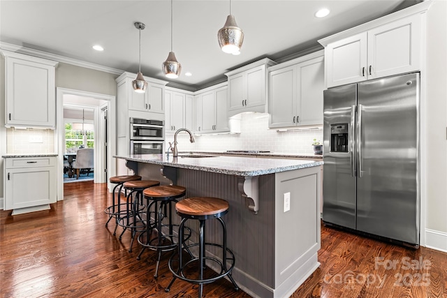 109 Trent Pines Dr, Mooresville, NC 28117 - kitchen with appliances with stainless steel finishes, tasteful backsplash, light stone counters, dark wood-style flooring, and recessed lighting