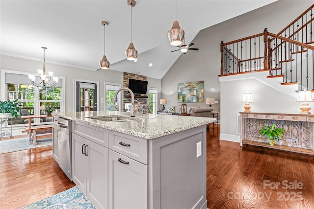 109 Trent Pines Dr, Mooresville, NC 28117 - kitchen featuring ceiling fan, a chandelier, dark wood-type flooring, stainless steel dishwasher, and light stone counters