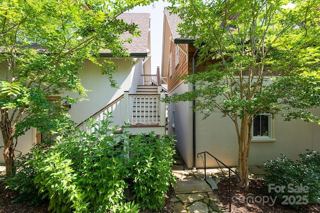 12 Fay Jones Ln, Black Mountain, NC 28711 - view of property exterior featuring stucco siding, a shingled roof, and stairs
