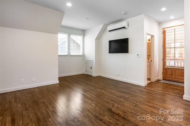12 Fay Jones Ln, Black Mountain, NC 28711 - unfurnished living room featuring a wall unit AC, recessed lighting, and dark wood-style floors