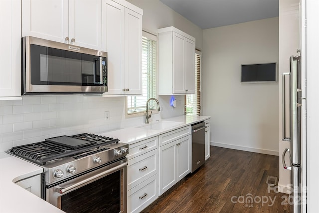 12 Fay Jones Ln, Black Mountain, NC 28711 - kitchen with stainless steel appliances, decorative backsplash, dark wood-style flooring, white cabinetry, and light countertops