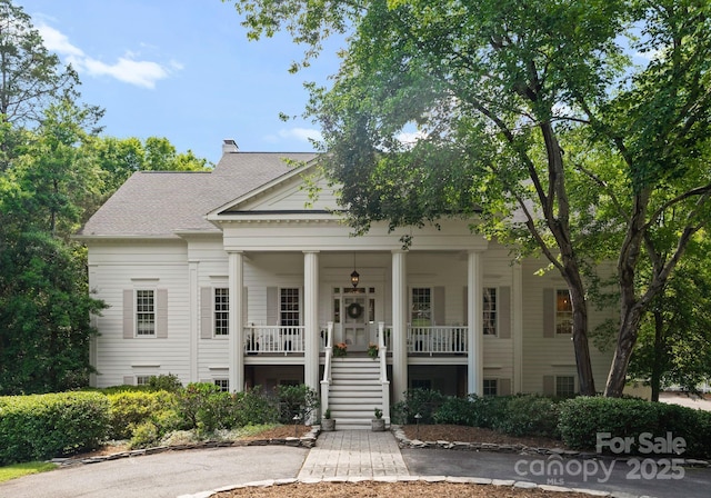 2324 Kingsmill Ter, Charlotte, NC 28270 - neoclassical home featuring stairway, a porch, and a chimney