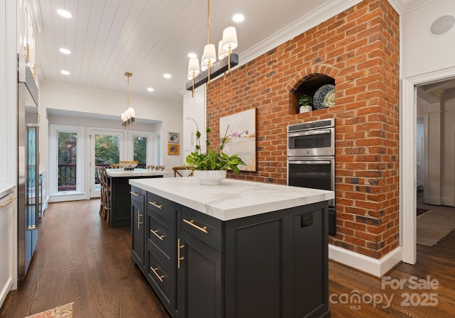 2324 Kingsmill Ter, Charlotte, NC 28270 - kitchen with a center island, dark cabinetry, dark wood-type flooring, decorative light fixtures, and recessed lighting