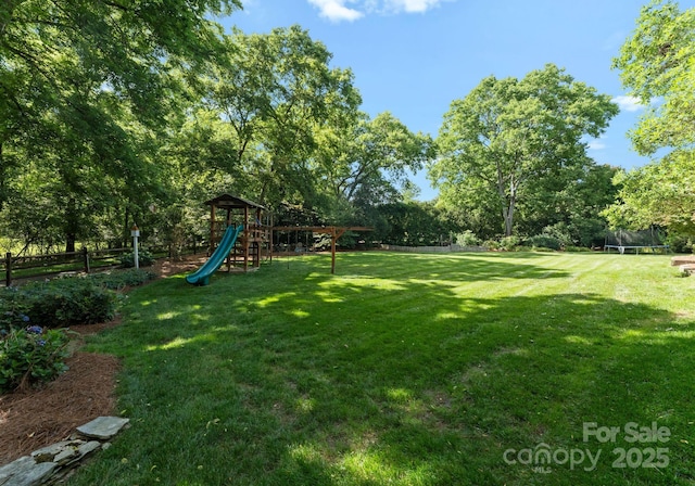 2324 Kingsmill Ter, Charlotte, NC 28270 - view of yard featuring a trampoline, a playground, and view of scattered trees