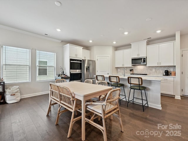 835 Windage Way, Pineville, NC 28134 - dining room with dark wood-type flooring, recessed lighting, and ornamental molding