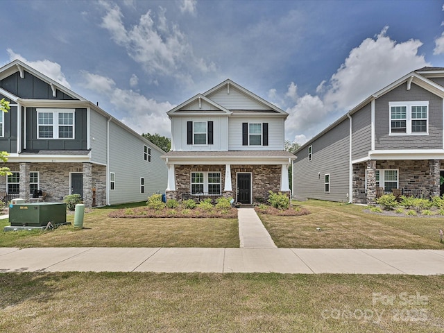 835 Windage Way, Pineville, NC 28134 - craftsman inspired home featuring a front lawn, stone siding, covered porch, and board and batten siding