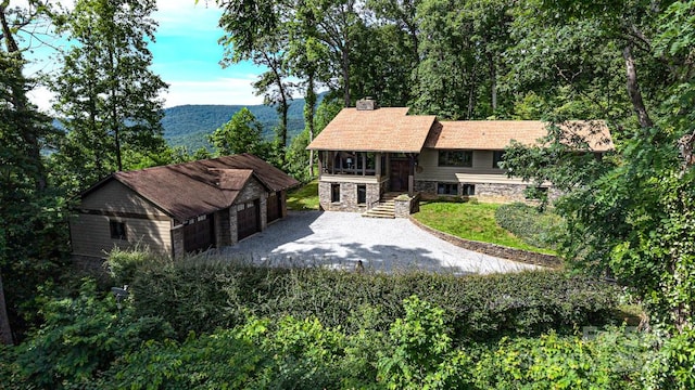 2045 Hogback Mountain Rd, Tryon, NC 28782 - view of front of home with stone siding, a chimney, an outdoor structure, and a detached garage