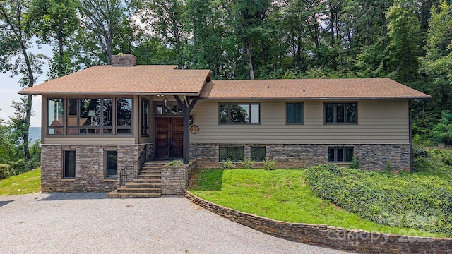 2045 Hogback Mountain Rd, Tryon, NC 28782 - view of front of property with a chimney, stone siding, a front lawn, and a shingled roof