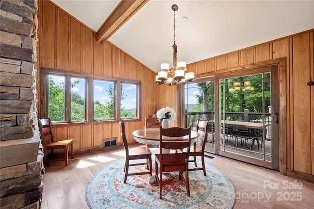 2045 Hogback Mountain Rd, Tryon, NC 28782 - dining area with a chandelier, wood walls, and light wood-style flooring