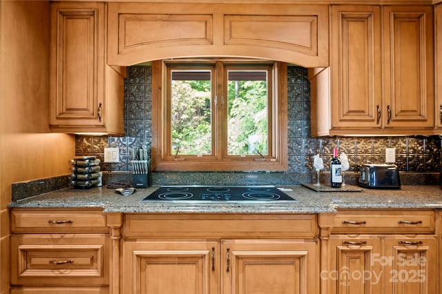2045 Hogback Mountain Rd, Tryon, NC 28782 - kitchen with black electric cooktop, tasteful backsplash, and light stone counters