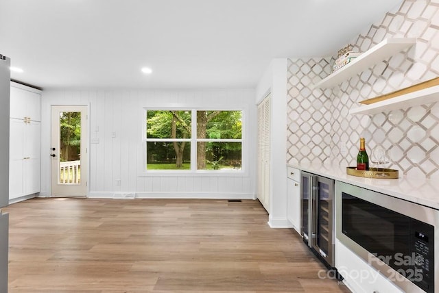 1426 Larkfield Ln, Charlotte, NC 28210 - indoor dry bar with stainless steel microwave, beverage cooler, light wood-type flooring, and recessed lighting