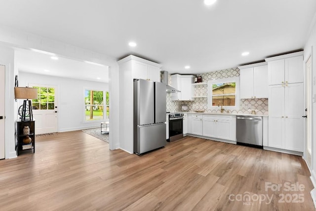 1426 Larkfield Ln, Charlotte, NC 28210 - kitchen with stainless steel appliances, open shelves, light countertops, tasteful backsplash, and light wood-type flooring