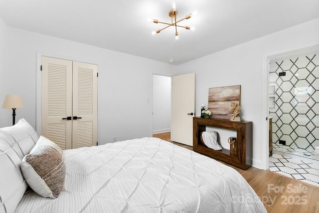 1426 Larkfield Ln, Charlotte, NC 28210 - bedroom with a chandelier, wood finished floors, and a closet