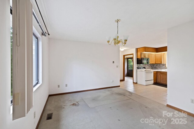 108 Deer Run Rd, Mills River, NC 28759 - unfurnished dining area featuring a chandelier, light carpet, and light tile patterned flooring