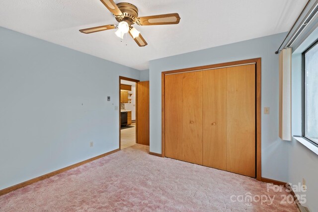 108 Deer Run Rd, Mills River, NC 28759 - unfurnished bedroom with a closet, carpet, multiple windows, and a ceiling fan