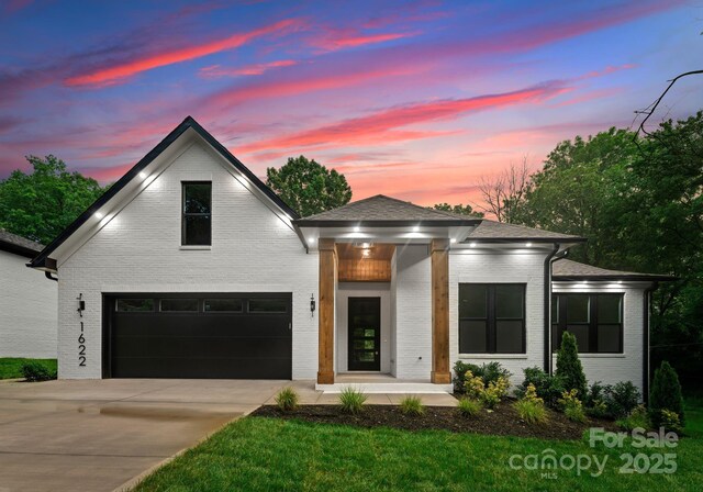 1622 Burtonwood Cir, Charlotte, NC 28212 - view of front facade with brick siding, concrete driveway, and a garage